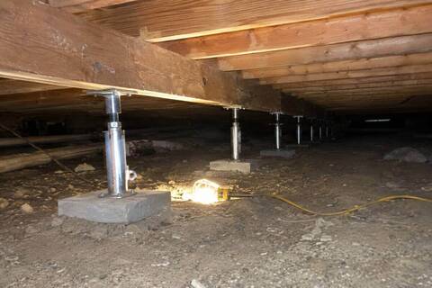 Adjustable steel piers under a pier-and-beam foundation