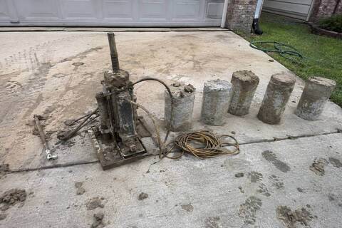 Hydraulic jack and concrete pier segments on site