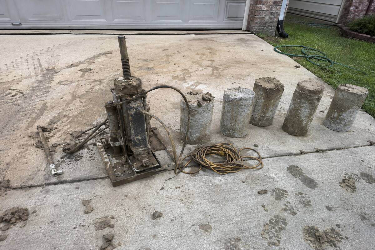 Hydraulic jack and concrete pier segments on site